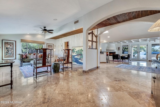 living room with french doors, vaulted ceiling, and ceiling fan