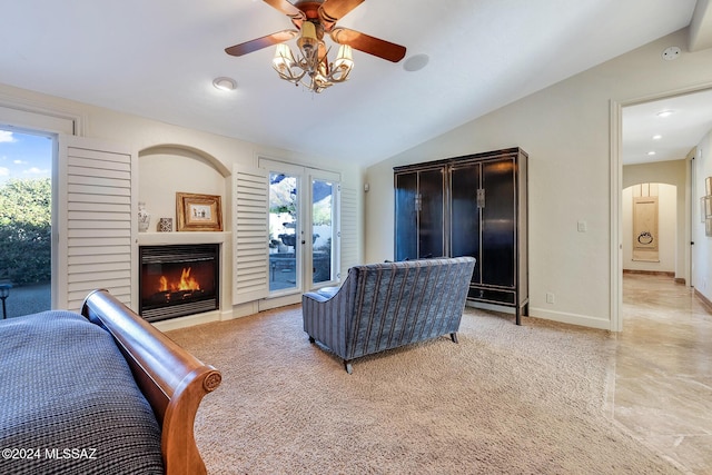 carpeted living room featuring plenty of natural light, ceiling fan, and lofted ceiling