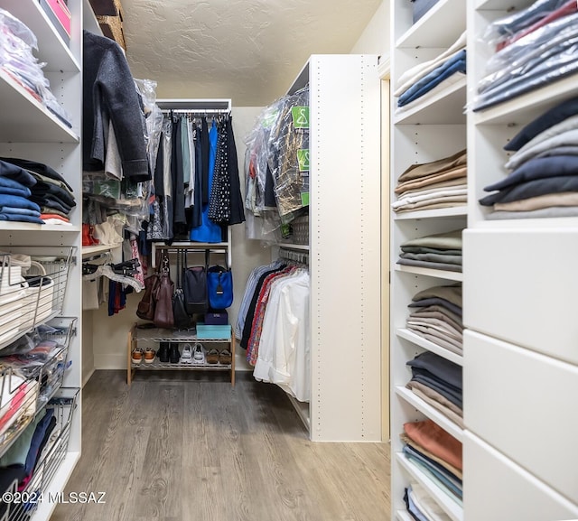 walk in closet featuring hardwood / wood-style floors