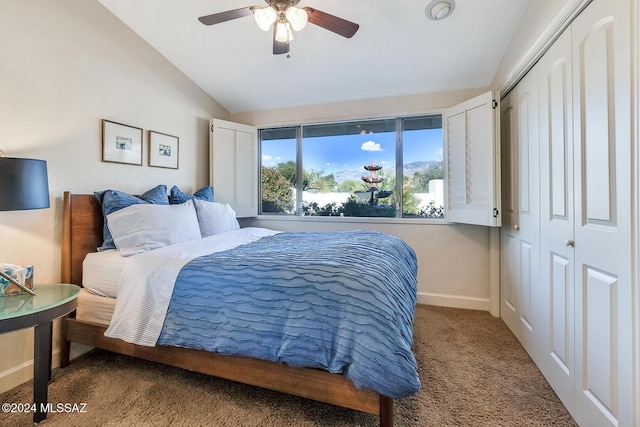 carpeted bedroom with ceiling fan, a closet, and lofted ceiling