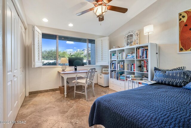 bedroom with ceiling fan, lofted ceiling, and a closet