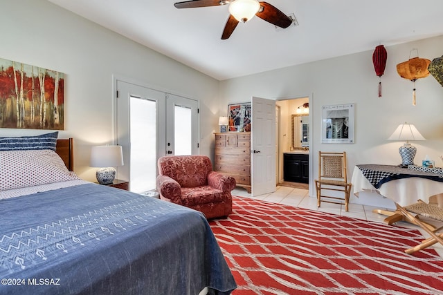 bedroom with tile patterned flooring, ensuite bathroom, ceiling fan, and french doors