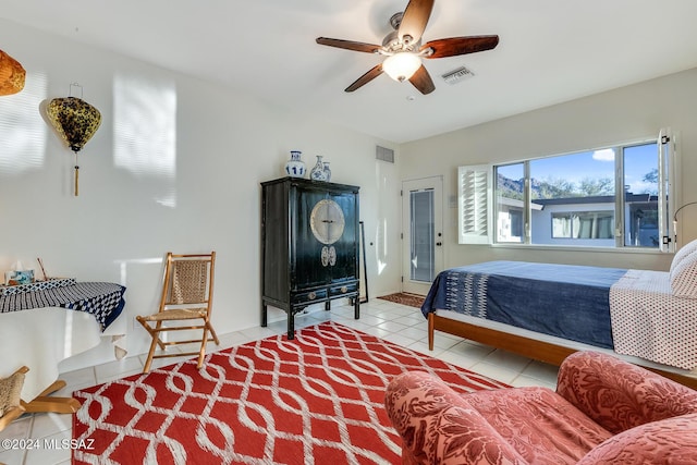 bedroom with ceiling fan and light tile patterned floors