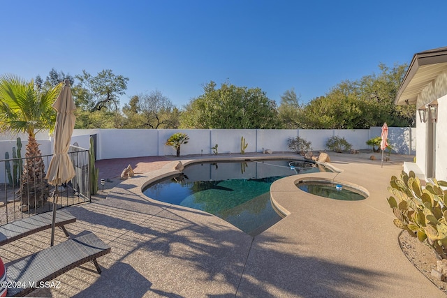 view of pool with a patio area and an in ground hot tub