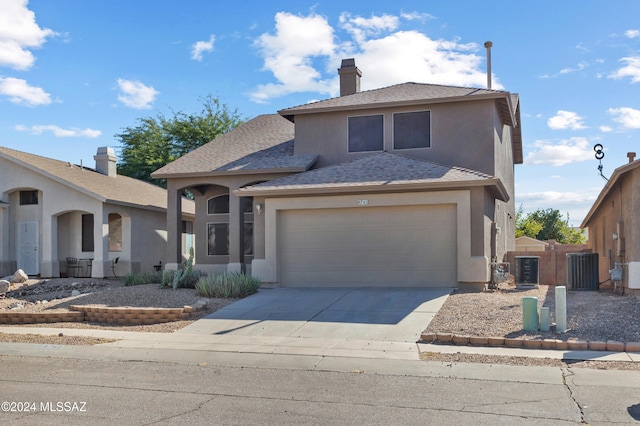 view of property with central AC and a garage