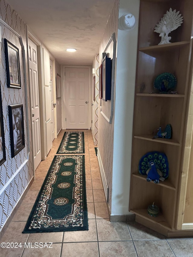 hallway with tile patterned flooring