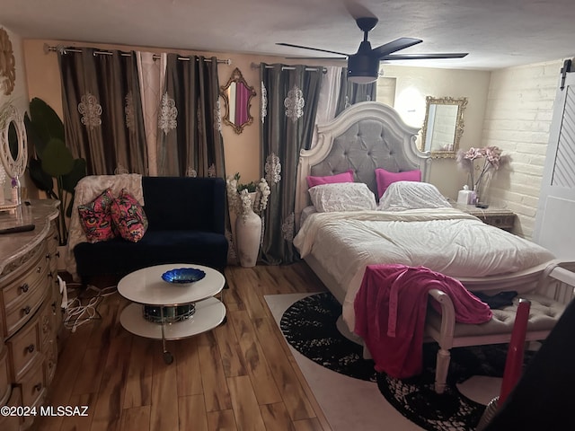 bedroom featuring wood-type flooring and ceiling fan