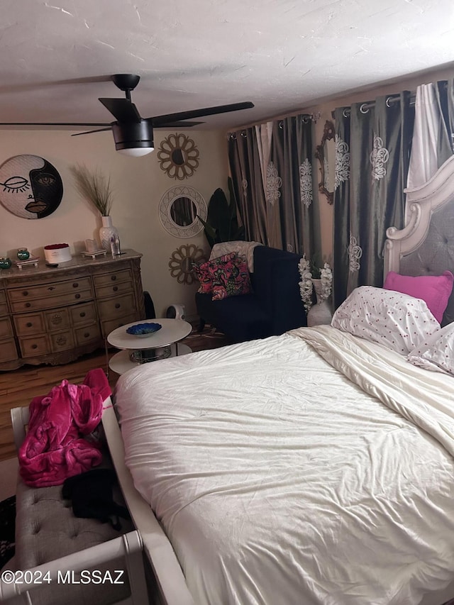 bedroom featuring ceiling fan and wood-type flooring