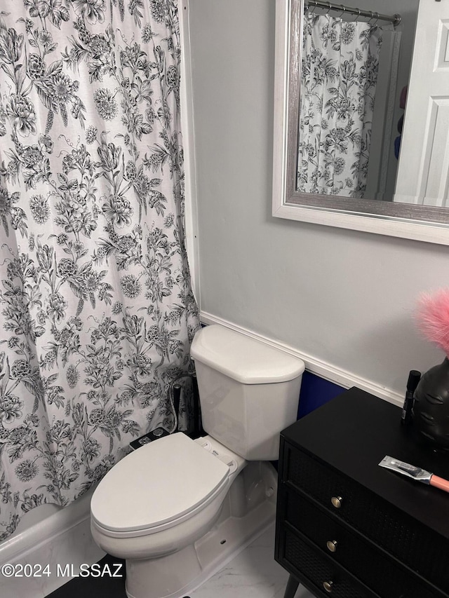 bathroom featuring toilet and a shower with shower curtain