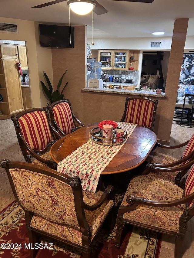 dining space featuring light tile patterned floors and ceiling fan