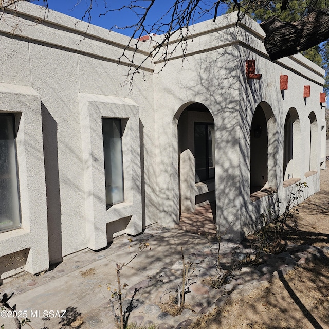 view of side of property featuring a patio