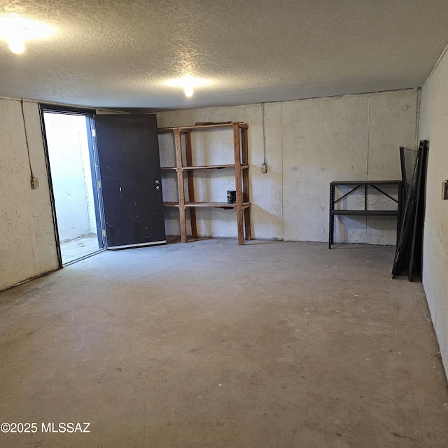 basement featuring a textured ceiling