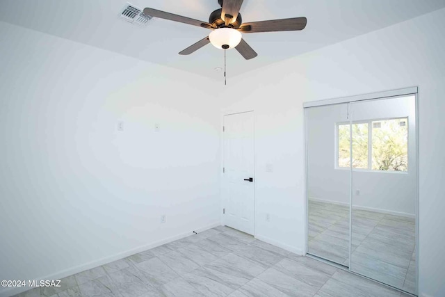 unfurnished bedroom featuring ceiling fan