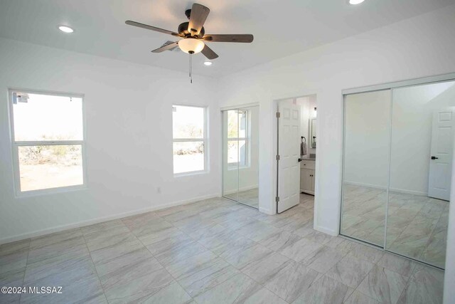 unfurnished bedroom featuring ensuite bath and ceiling fan