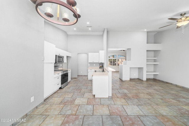 kitchen with white cabinetry, sink, a high ceiling, tasteful backsplash, and appliances with stainless steel finishes