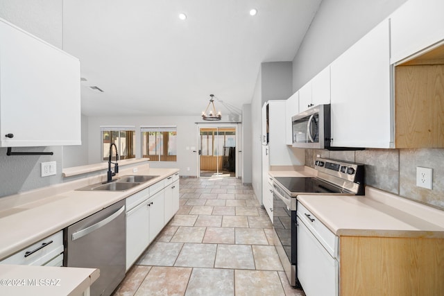 kitchen featuring white cabinetry, sink, stainless steel appliances, an inviting chandelier, and tasteful backsplash