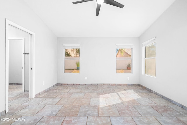 unfurnished room with ceiling fan, a healthy amount of sunlight, and lofted ceiling