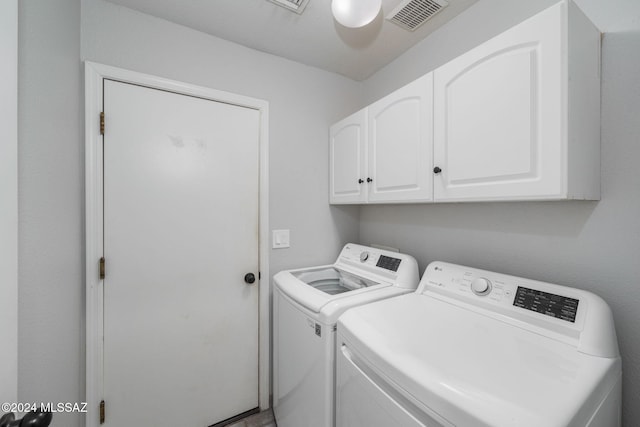 washroom with cabinets and independent washer and dryer