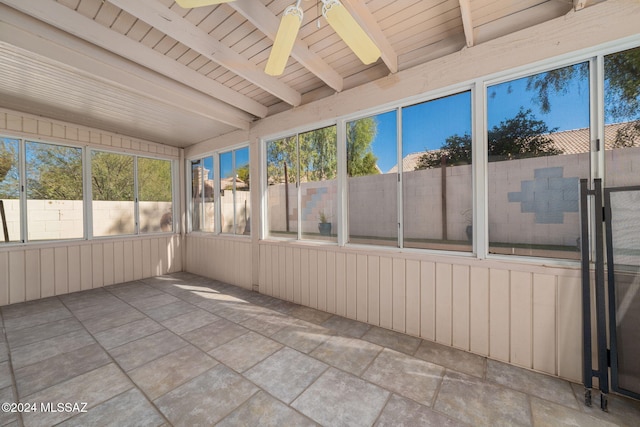 unfurnished sunroom featuring beam ceiling, ceiling fan, and wood ceiling