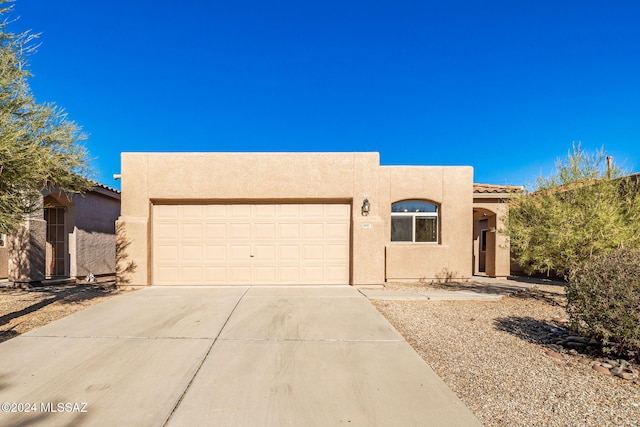 southwest-style home featuring a garage