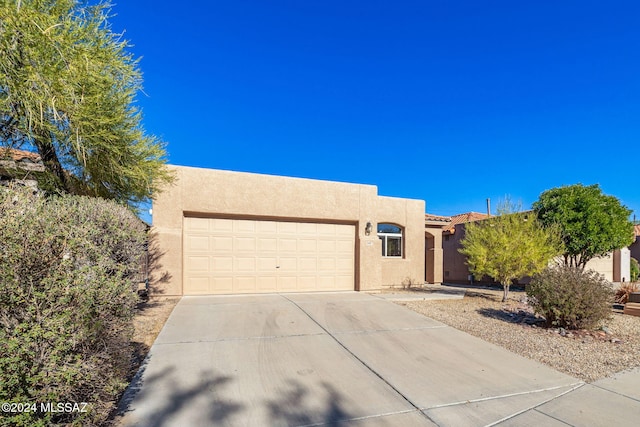 southwest-style home featuring a garage