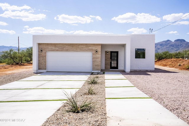 view of front of property with a mountain view and a garage