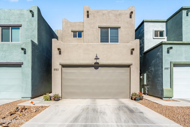 pueblo-style home with a garage