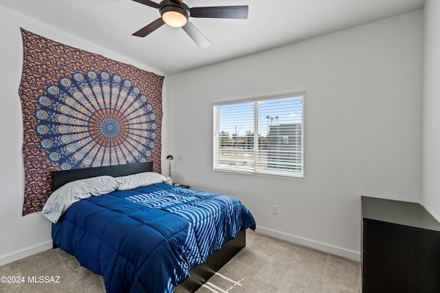 bedroom with ceiling fan and light carpet