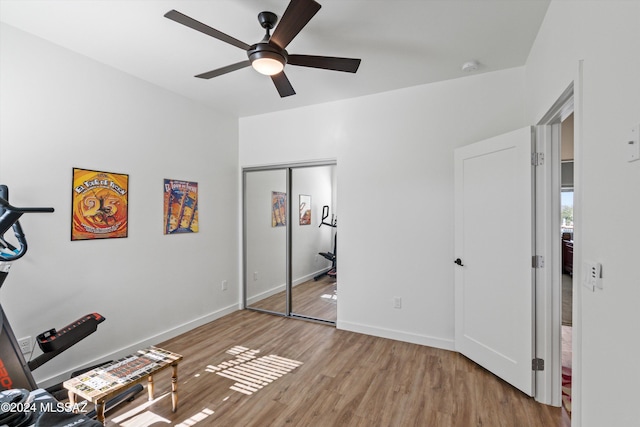 bedroom with ceiling fan, a closet, and light hardwood / wood-style flooring