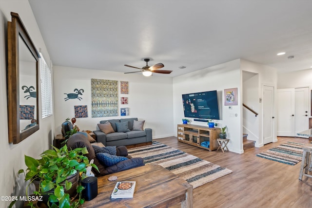 living room featuring ceiling fan and wood-type flooring