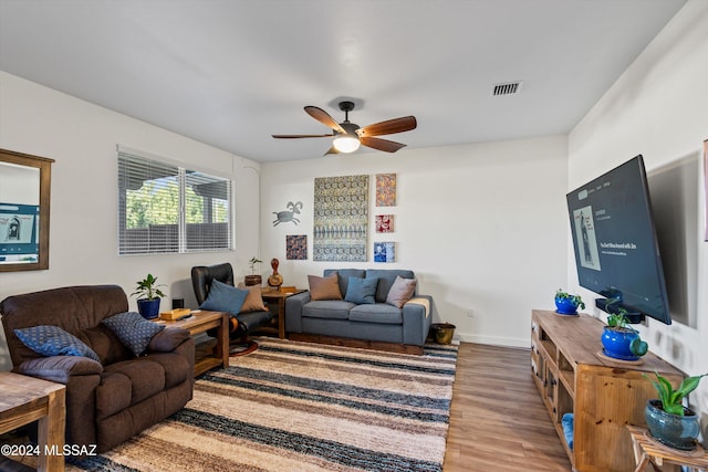 living room featuring ceiling fan and hardwood / wood-style flooring