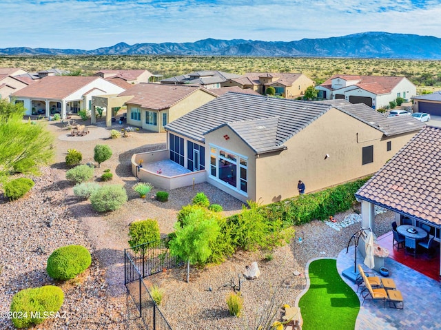 birds eye view of property with a mountain view