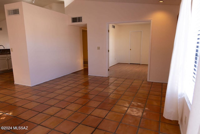 tiled empty room with high vaulted ceiling