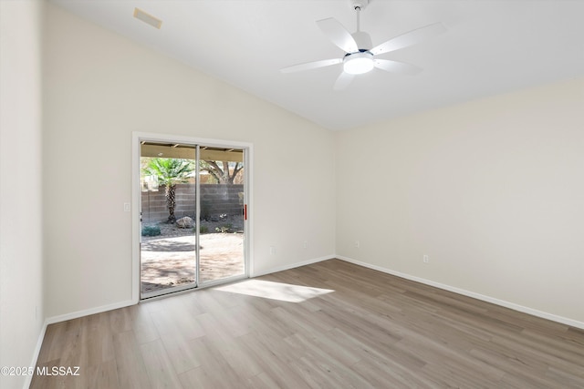 spare room with light hardwood / wood-style floors, ceiling fan, and vaulted ceiling