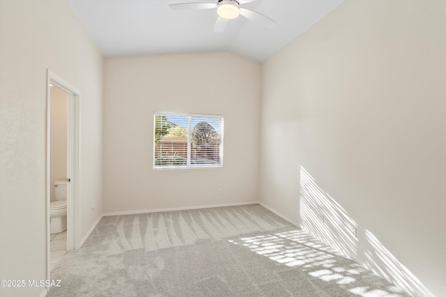 unfurnished room featuring ceiling fan, light colored carpet, and vaulted ceiling