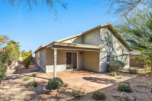 back of property with a patio