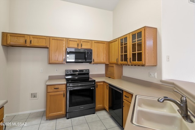 kitchen featuring sink, range with electric cooktop, light tile patterned floors, and dishwasher