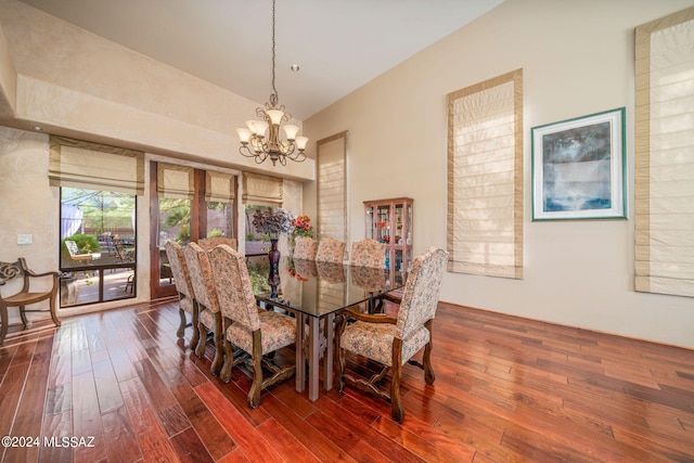 dining space featuring dark hardwood / wood-style floors and an inviting chandelier