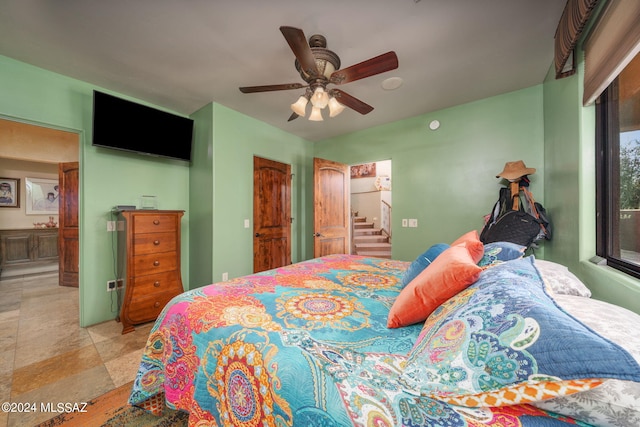 bedroom featuring ceiling fan and connected bathroom