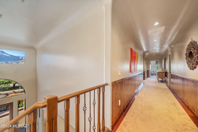 hallway with wood walls