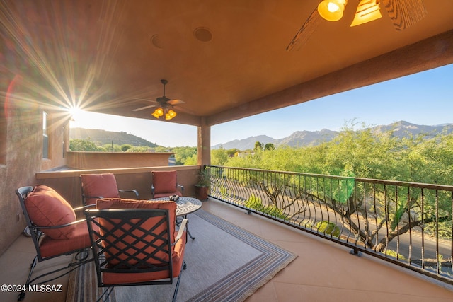 view of patio / terrace with ceiling fan, a balcony, and a mountain view