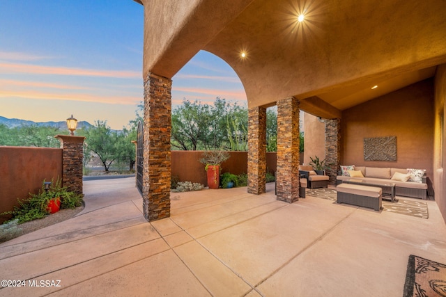 patio terrace at dusk featuring outdoor lounge area