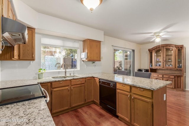 kitchen featuring kitchen peninsula, ventilation hood, sink, black dishwasher, and dark hardwood / wood-style floors