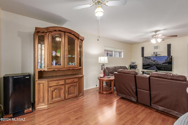 living room featuring ceiling fan and light hardwood / wood-style floors