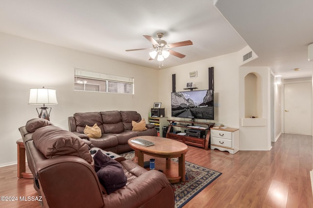 living room with light wood-type flooring and ceiling fan