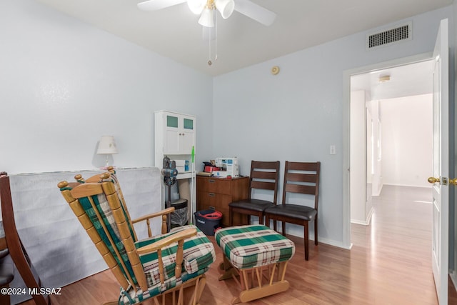 living area featuring ceiling fan and light hardwood / wood-style floors