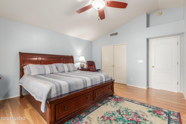 bedroom with ceiling fan, a closet, lofted ceiling, and light wood-type flooring