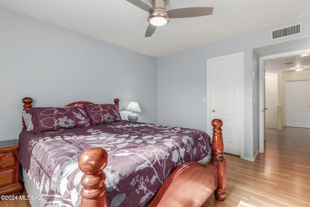 bedroom with ceiling fan and light hardwood / wood-style flooring