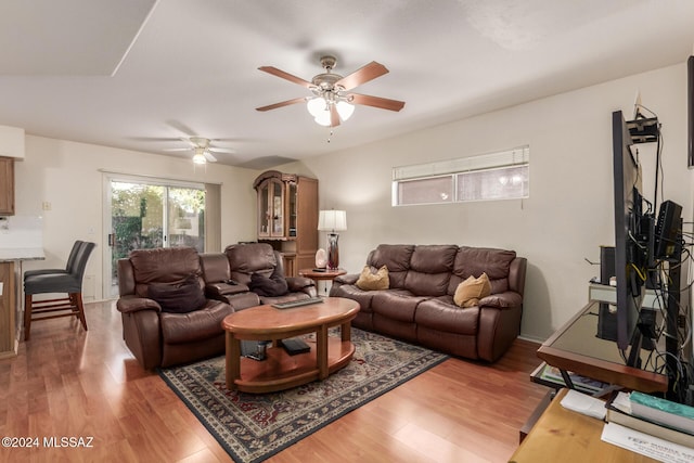 living room featuring ceiling fan and hardwood / wood-style flooring