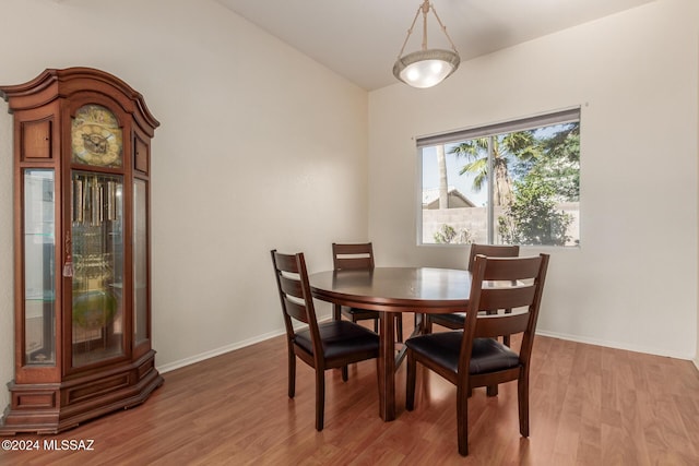 dining space with wood-type flooring